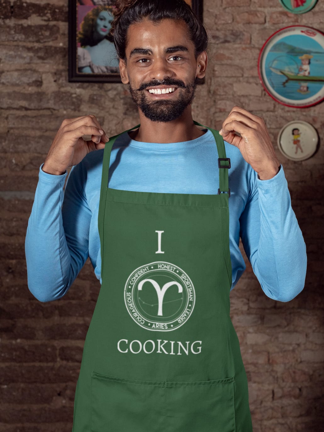 man with a hair bun wearing an apron